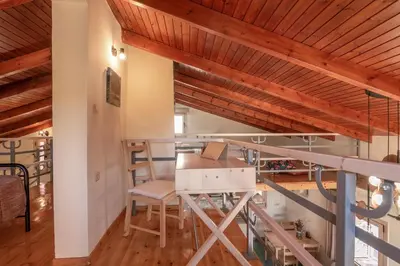 a room with wooden ceilings and a table and chairs at Avocado Villas in Chania Town