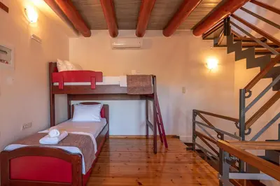 a room with two bunk beds and a staircase at Avocado Villas in Chania Town