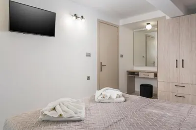 a bedroom with a bed with two towels on it at Quarters Luxury Apts in Chania Town