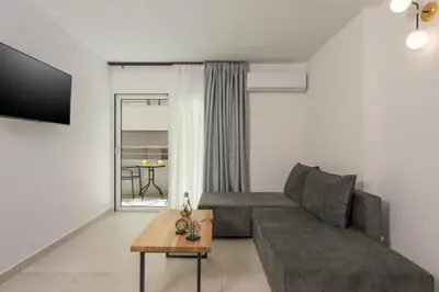 a living room with a couch and a table at Quarters Luxury Apts in Chania Town
