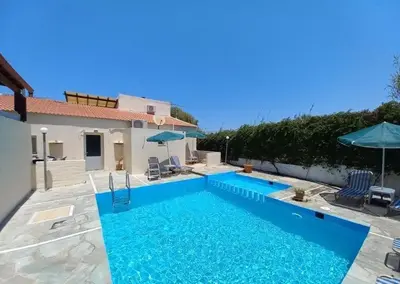 a swimming pool in front of a house at Casa Constans in Maleme