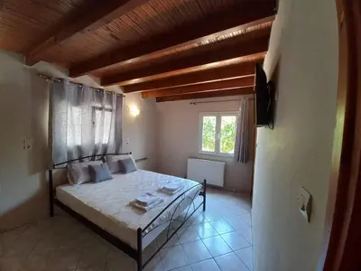 a bedroom with a bed in a room with a window at Casa Constans in Maleme