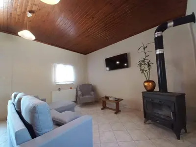 a living room with a couch and a wood stove at Casa Constans in Maleme