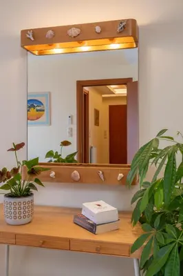 a mirror sitting on top of a wooden table at Aris Apartment in Palaiochóra