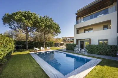 a swimming pool in front of a house at Luxury Villas near The Sea With Heated Pool in Kato Daratso