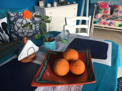 a table with a plate of oranges on a table at Great sea-view apartment. in Khóra Sfakíon
