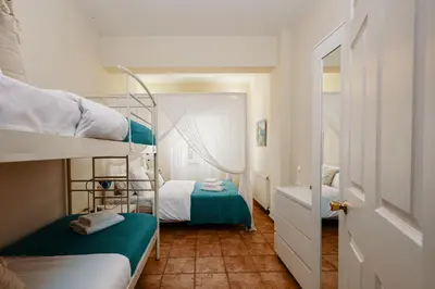 a small room with two bunk beds and a hallway at Villa Paparouna in Chania Town