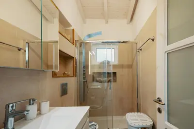 a bathroom with a shower with a glass door at Villa Paparouna in Chania Town