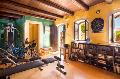 a gym with bikes and exercise equipment in a room at Samonas - Blue villa Mantzourana in Khiliomoudhoú