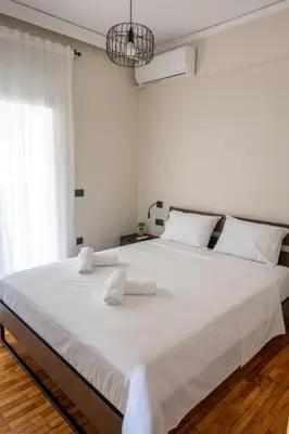 a large white bed with two white towels on it at CENTRAL ROOF NK CHANIA in Chania Town