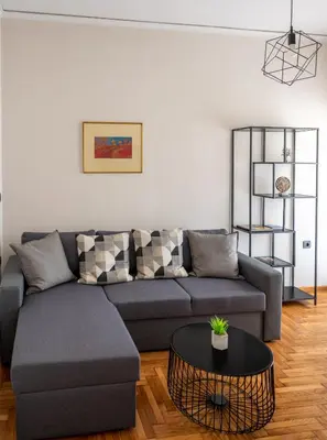 a living room with a couch and a table at CENTRAL ROOF NK CHANIA in Chania Town