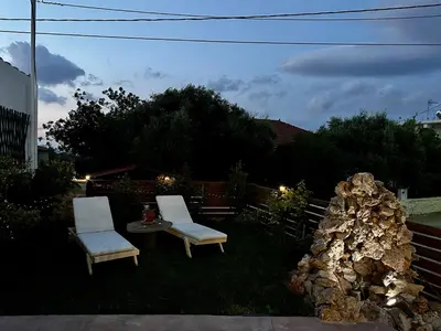 two chairs and a table in a yard at DESTAN & JULIETTE SEA VIEW Villa in Kamisianá