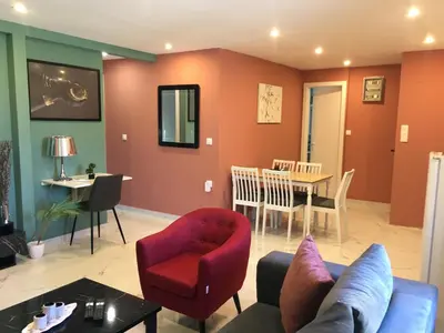 a living room with a couch and a table at Πολυτελές οροφοδιαμέρισμα για ονειρικές διακοπές! in Chania Town