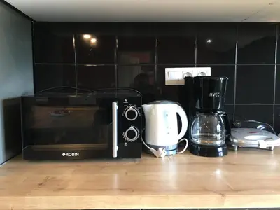 a kitchen counter with a microwave and a coffee maker at Άνετο και πολυτελές οροφοδιαμέρισμα 2 in Chania Town