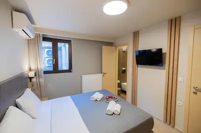 a hotel room with a bed with two towels at Villy Luxury Home by the Sea 1 in Ayiá