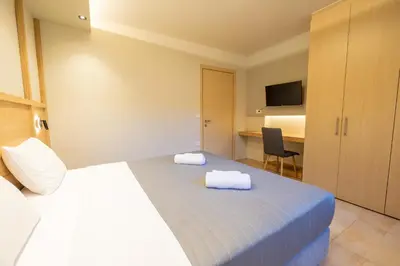 a hotel room with a bed with towels on it at Villy Luxury Home by the Sea 1 in Ayiá