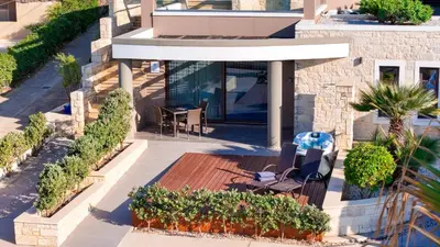 a view of a house with a bench and plants at Villy Luxury Home by the Sea 2 in Ayiá