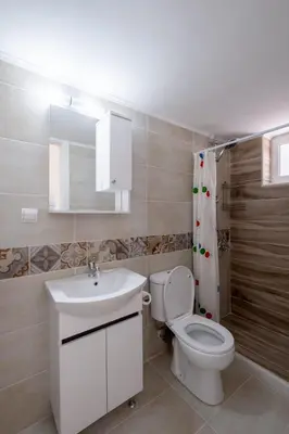 a white bathroom with a toilet and a sink at Jasmine Home by the Sea by 8essentially in Kalyves