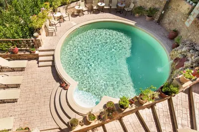 an overhead view of a swimming pool in a resort at Samonas - Orange villa Diktamos in Khiliomoudhoú