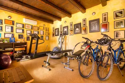 two bikes parked in a room with a gym at Samonas - Orange villa Diktamos in Khiliomoudhoú
