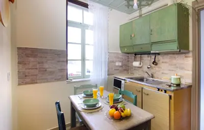 a kitchen with a table with fruit on it at Auntie's home by Chania Old Harbor in Chania Town
