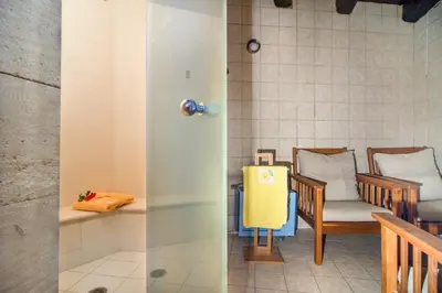 two views of a room with chairs and a table at Samonas - Green villa Faskomilia in Chania Town