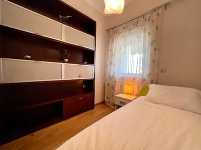 a bedroom with a white bed and a window at Central apartment in quiet neighborhood near sandy beach in Chania Town