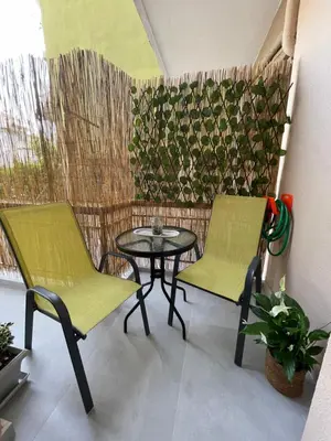 a patio with two chairs and a table on a balcony at The house of JohnKou in Chania Town
