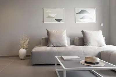 a living room with a couch with a hat on a table at Noemie Luxury Suites in Chania Town