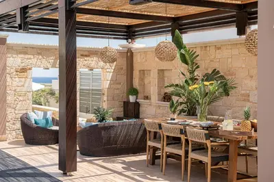 an outdoor patio with a table and chairs at Villa Peacock with Spa Facilities in Daratso