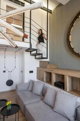 a living room with a couch and a mirror at Skins Concept Boutique Apartment in Chania Town