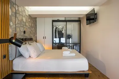 a bedroom with a bed with two towels on it at Skins Concept Boutique Apartment in Chania Town