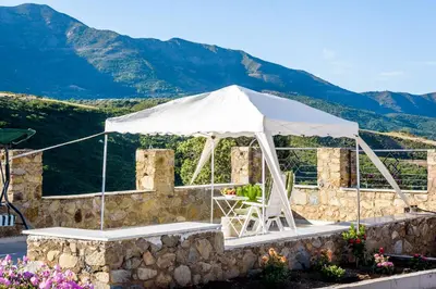 a white tent with mountains in the background at Ktima Abella ✩ Organic Garden ✩ Absolute Privacy in Élos