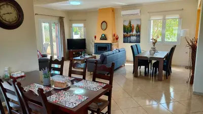 a living room with a table and a dining room at Pazinos/Neveli Cottage in Galangádhos