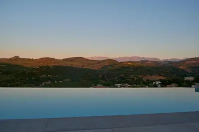 a pool with a view of the mountains at Villa Olive Valley in Loutrákion