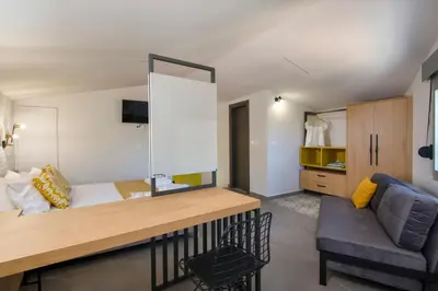 a small room with a bed and a couch at Casa Di Camomilla in countryside in Chania Town
