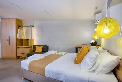 a bedroom with a large bed and a chair at Casa Di Camomilla in countryside in Chania Town