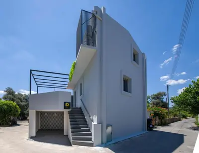 a white building with stairs on the side of it at Casa Di Camomilla in countryside in Chania Town