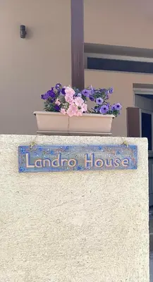 a sign that says londoria house with a pot of flowers at Landro House in Kissamos