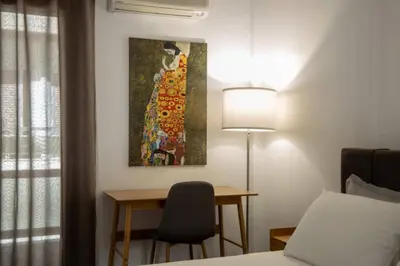 a bedroom with a desk and a painting on the wall at Sfakion 6 apartment in Chania Town
