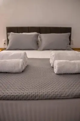 a large bed with two towels on top of it at Sfakion 6 apartment in Chania Town