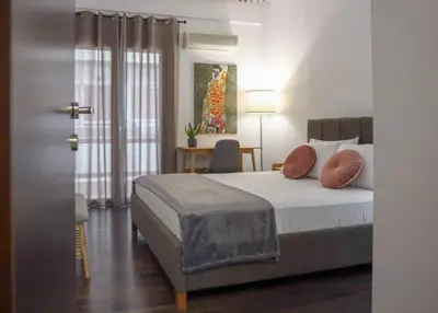 a bedroom with a bed with pillows on it at Sfakion 6 apartment in Chania Town