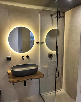 a bathroom with a bath tub and a mirror at Nidus President in Souda