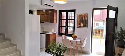 a kitchen with a table and chairs in a room at Canevaro Twins (South) in Chania Town