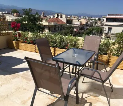 a group of chairs and a table on a balcony at Canevaro Twins (South) in Chania Town