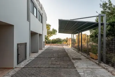 an empty hallway of a white building with awning at Efrossini Suites in Kounoupidhianá