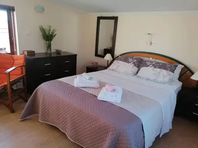 a bedroom with a bed with two towels on it at Casa Ag.Apo in Daratso
