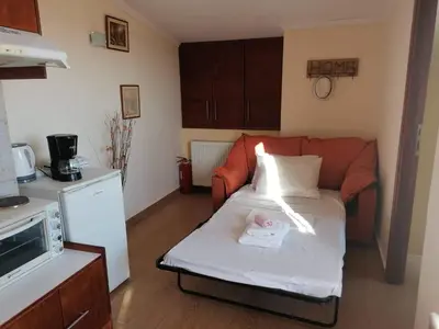 a small living room with a couch with a baby on it at Casa Ag.Apo in Daratso
