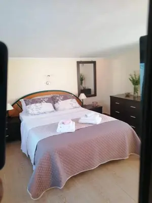 a bedroom with a bed with two towels on it at Casa Ag.Apo in Daratso