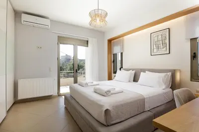 a bedroom with a bed and a table and a window at Quiet Villa Aviana,garden, heated pool,BBQ,jacuzzi in Gerani Chanion